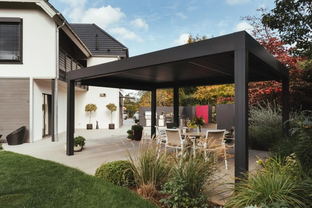 Contemporary backyard with manicured lawn, trees, and a wooden gazebo in a landscaped garden retreat.