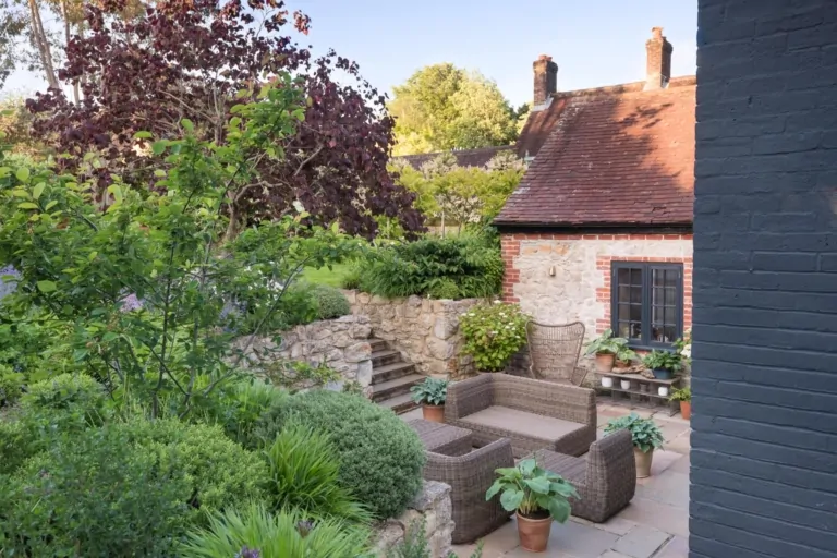 Wide view of a layered Surrey garden with shrubs, perennials, and structured planting, showcasing bespoke and high-end landscaping.